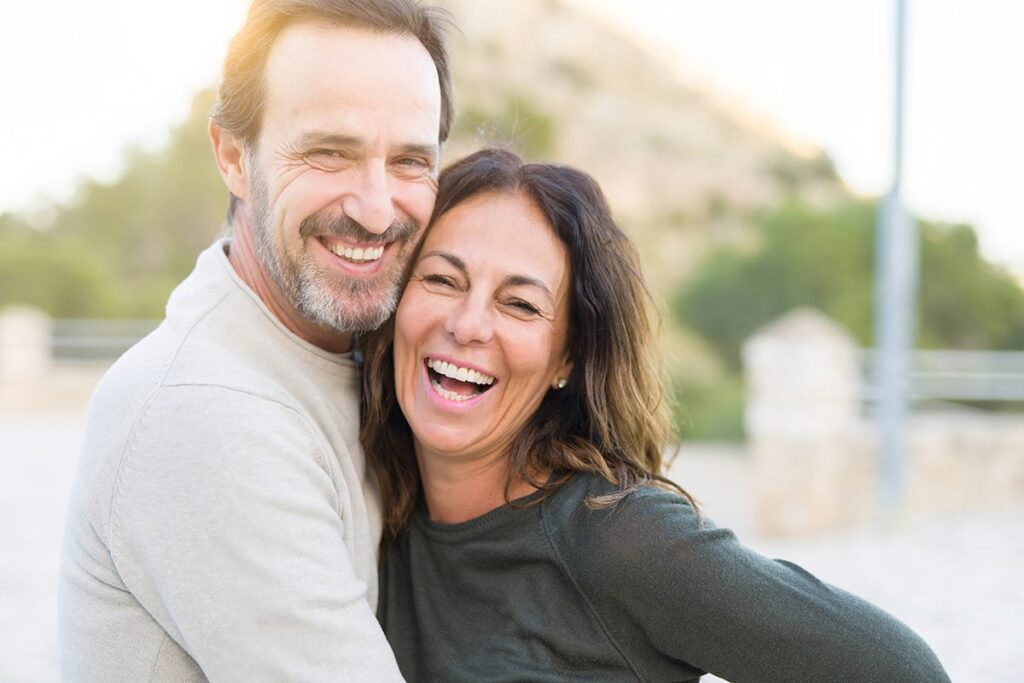 older couple lauging smiling at camera