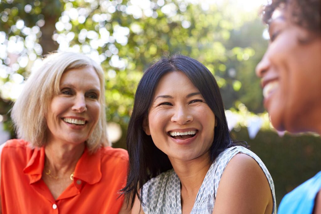 women smiling talking with friends