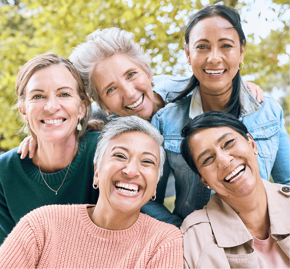 women smiling for picture together mobile
