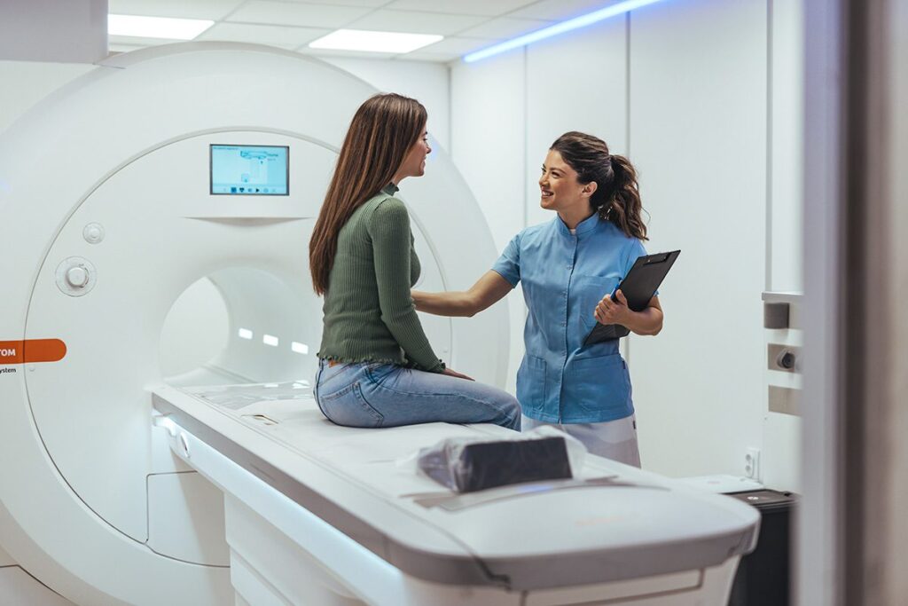 Healthcare Technician Assisting Woman During CT