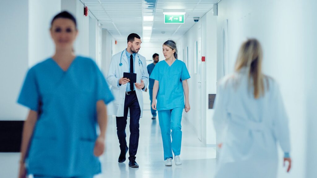 hospital hallway with doctor and nurse walking